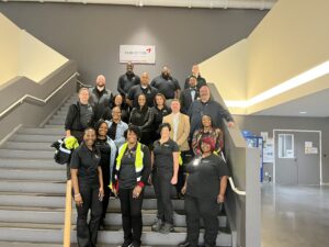Industry Tour group poses on the steps at Kumho Tire.