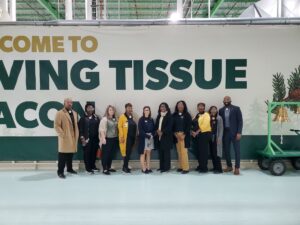 Industry tour group poses in front of Irving Tissue entrance.